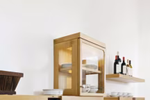 Esprit tradition - Cet aménagement se compose d'un système coulissant pour les verres, le lutrin pour déposer son livre de cuisine et le mini-vaisselier rappelant la forme d'un garde-manger. Collection "Mémoire", La Cornue.