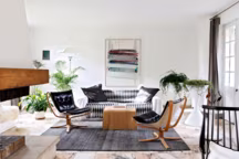 Mobilier vintage, œuvres d'artistes et cheminée dans le lumineux salon.