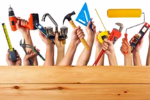 Hands with construction tools. House renovation background.